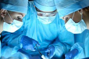 Surgeons working together to determine the best method to close a wound