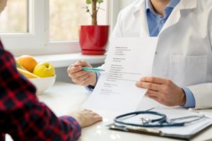 A patient discussing post-operative wound care with their physician